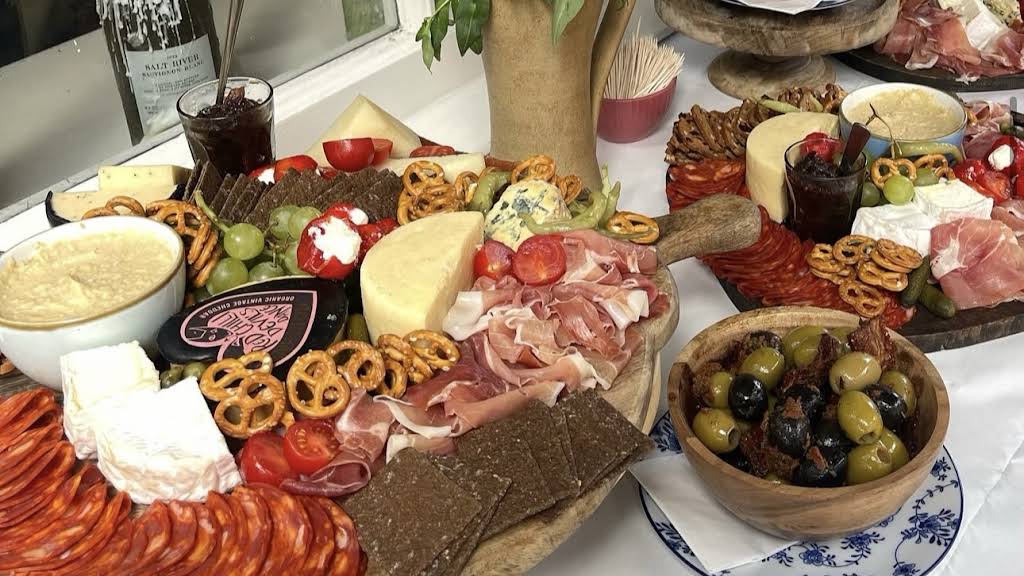 Cheese, sliced meats, olives and other small bites on a table at General Store Winchester