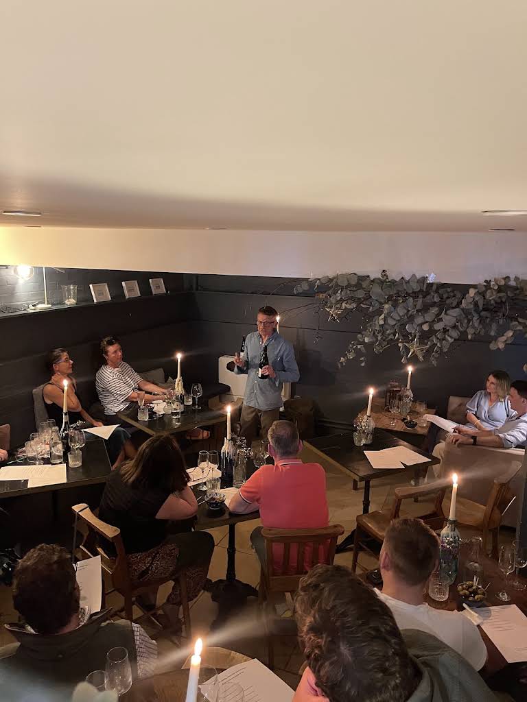 An evening scene inside General Store Winchester, with guests in the softly lit interior